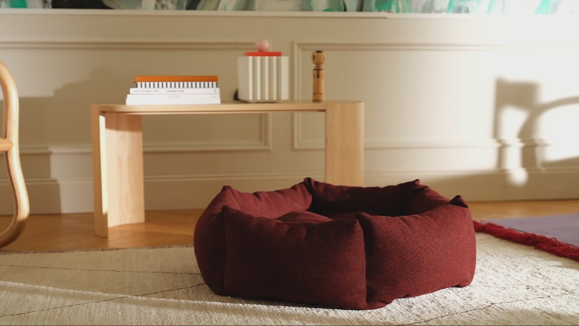 A happy dog lounging on a luxurious Kanto dog bed, reflecting the brand's commitment to high-quality and sustainable comfort.